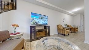 Niagara Falls (Hospital) townhouse for rent - A living room with a flat screen TV and a glass coffee table.