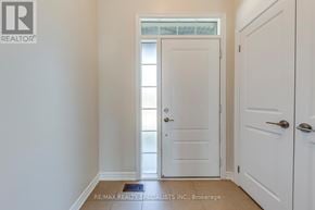 Hamilton (Vincent) apartment for rent - A white door is in a hallway with a RE/MAX Realty sign on the wall.