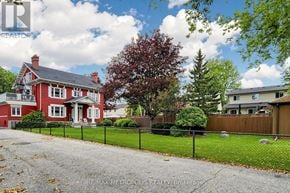 Oshawa (Lakeview) multi-family for rent - A red house with a black fence in front of it.