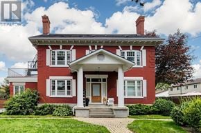 Oshawa (Lakeview) multi-family for rent - A red brick house with a white front porch.