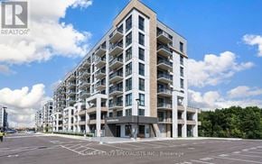 Milton (Cb Cobban) condo for rent - A modern apartment building with a clear blue sky above.