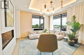 Milton (Cb Cobban) condo for rent - A modern living room with a fireplace and a view of the outdoors.