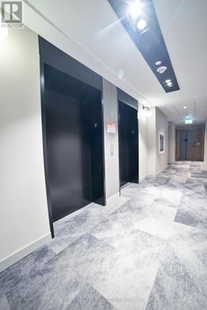 Milton (Cb Cobban) condo for rent - A hallway with a black door on the left and a blue door on the right.