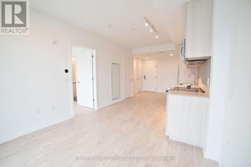 Milton (Cb Cobban) condo for rent - A white room with a kitchenette and a bar area.
