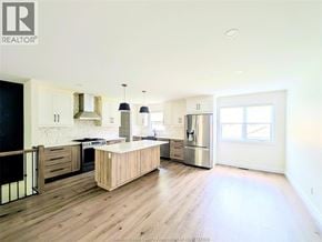 Windsor apartment for rent - A kitchen with wooden floors and a large island.