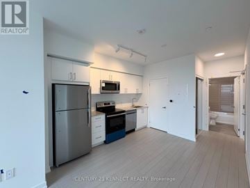 Toronto (Humber Heights) condo for rent - A kitchen with white cabinets and a stainless steel refrigerator.