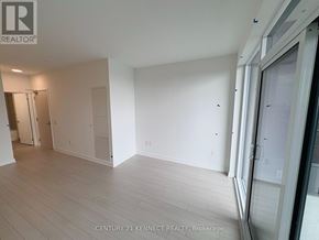 Toronto (Humber Heights) condo for rent - A spacious room with white walls and wooden flooring, part of a property brokerage by Century 21 Kennect Realty.