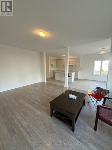 Loyalist (Bath) apartment for rent - A living room with a wooden coffee table and a red chair.