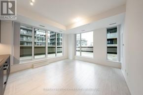 Toronto (Waterfront Communities) condo for rent - A spacious room with a large window and a view of a building outside.