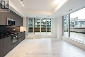Toronto (Waterfront Communities) condo for rent - A spacious kitchen with a view of a building across the street.
