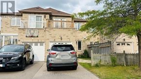 Richmond Hill (Rouge Woods) townhouse for rent - Two cars parked in front of a brick house.