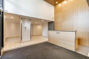 Surrey apartment for rent - A reception area with a wooden counter and a white door.