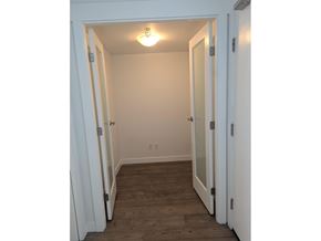 Surrey apartment for rent - A gym with a variety of equipment including a treadmill, weights, and a television.