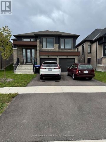Wasaga Beach apartment for rent - A house with a car parked in front of it.