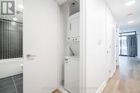 Hamilton (Beasley) condo for rent - A white bathroom with a tub, sink, and a small closet.