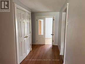Georgina (Keswick South) apartment for rent - A hallway with white doors and a wooden floor.
