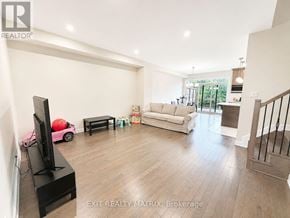 Russell townhouse for rent - A living room with a television, sofa, and a red ball.