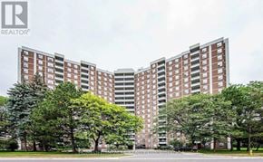Toronto (Flemingdon Park) condo for rent - A large building with a lawn in front of it.