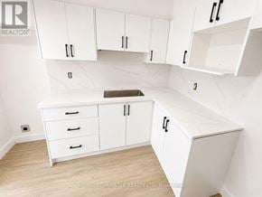 Toronto (Flemingdon Park) condo for rent - A white kitchen with a counter and cabinets.