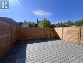 Toronto (Yonge-St. Clair) apartment for rent - A wooden deck with a sunny sky in the background.