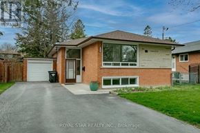Toronto (Kingsview Village-The Westway) apartment for rent - A house with a brown brick exterior and a white garage door is for sale.