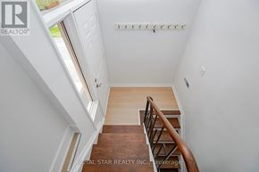 Toronto (Kingsview Village-The Westway) apartment for rent - A staircase with a wooden handrail and a white wall.