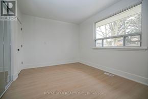 Toronto (Kingsview Village-The Westway) apartment for rent - A white room with a window and wooden flooring.