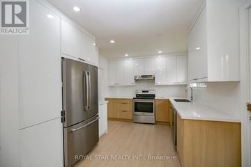 Toronto (Kingsview Village-The Westway) apartment for rent - A modern kitchen with wooden cabinets and stainless steel appliances.