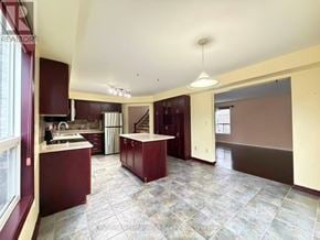 Guelph (Pineridge/Westminster Woods) apartment for rent - A kitchen with a maroon and beige color scheme.