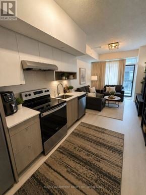 Burlington (Lasalle) condo for rent - A modern kitchen with a large island and a dining area.