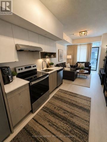 Burlington (Lasalle) condo for rent - A modern kitchen with a large island and a dining area.