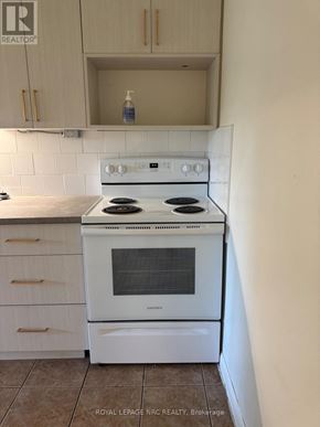 Niagara Falls (Dorchester) multi-family for rent - A white stove in a kitchen with white cabinets.