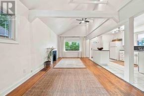Toronto (Clairlea-Birchmount) apartment for rent - A spacious room with wooden floors and white walls.