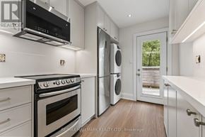Toronto (The Beaches) duplex for rent - A modern kitchen with a stainless steel oven and microwave above the stove.