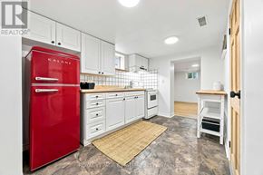 Toronto (Clairlea-Birchmount) apartment for rent - A kitchen with a red fridge and white cabinets.
