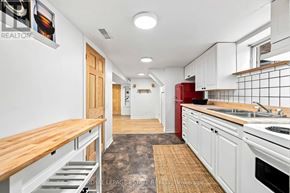 Toronto (Clairlea-Birchmount) apartment for rent - A kitchen with white cabinets and a red fridge.