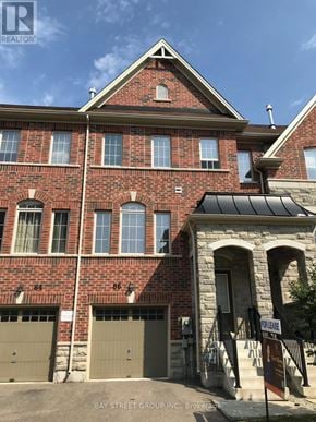 Richmond Hill (Westbrook) townhouse for rent - A red brick building with a sign that says Bay Street Group Inc Brokerage.