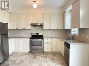 Richmond Hill (Westbrook) townhouse for rent - A kitchen with white cabinets and a tile floor.