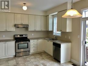 Richmond Hill (Westbrook) townhouse for rent - A kitchen with white cabinets and a stainless steel dishwasher.