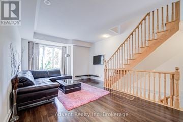 Markham (Commerce Valley) townhouse for rent - A living room with a leather couch and a red rug.