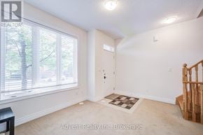Markham (Commerce Valley) townhouse for rent - A room with a window, a door, and a staircase.