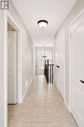 Barrie (Innis-Shore) apartment for rent - A long hallway with white walls and a tiled floor.