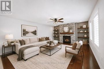 Barrie (Innis-Shore) apartment for rent - A living room with a fireplace and a painting on the wall.
