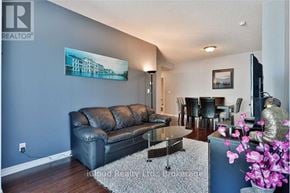 Mississauga (Hurontario) condo for rent - A living room with a black leather couch and a painting on the wall.