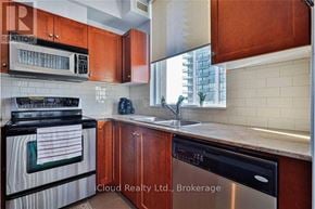 Mississauga (Hurontario) condo for rent - A kitchen with wooden cabinets and a black stove top oven.
