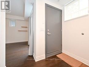 Toronto (Dovercourt-Wallace Emerson-Junction) townhouse for rent - A room with a grey door and a wooden floor.