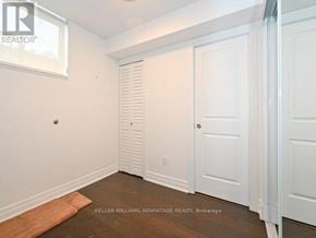 Toronto (Dovercourt-Wallace Emerson-Junction) townhouse for rent - A room with white walls and a wooden floor.