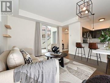Toronto (Dovercourt-Wallace Emerson-Junction) townhouse for rent - A modern living room with a grey sofa and a black and white rug.