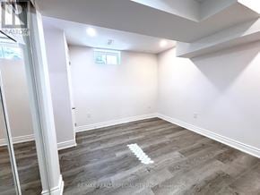 Milton (Be Beaty) apartment for rent - A room with wooden flooring and white walls, with a window and a door visible.