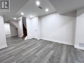 Milton (Be Beaty) apartment for rent - A spacious room with a staircase and a door.